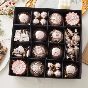Pink and rose gold Christmas ornament set with diverse shapes in a gift box