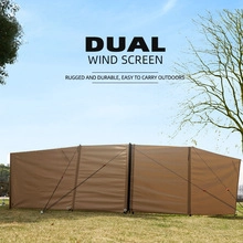 Macro detail of khaki outdoor dual wind screen for camping setup on green grass