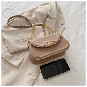 Beige faux leather chain bag with gold buckle shown next to a phone for scale