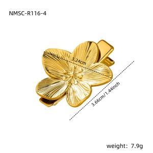 Macro shot of golden floral hair clip detailing metallic petal texture and dimensions