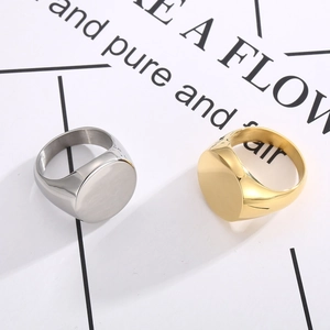 Polished gold and silver signet rings with round mirror finish on white cards