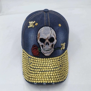 Washed denim baseball cap with rose skull embroidery and yellow rhinestones