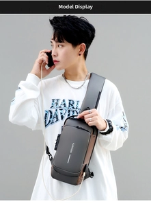 Detailed side view of dark gray chest bag showing anti-theft lock and USB charging port