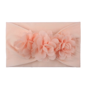 Detail of pink chiffon flowers on a soft stretch nylon baby headband for girls