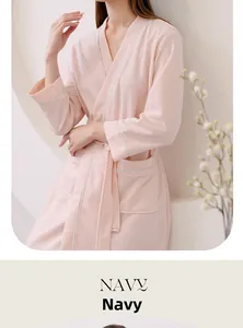 Detail of pink waffle texture bathrobe with contrast piping and a side patch pocket