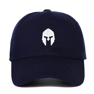 Close-up of deep blue cotton baseball cap featuring a white embroidered gladiator helmet