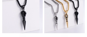 Three-color Vajra pendant necklace in black, gold and silver finishes on a white background