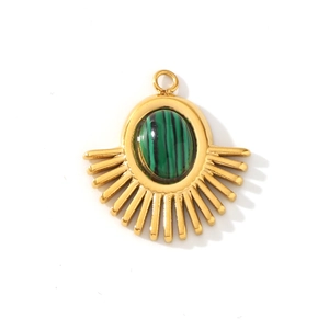 Detail of 18K gold sun pendant featuring natural green malachite and sunburst pattern