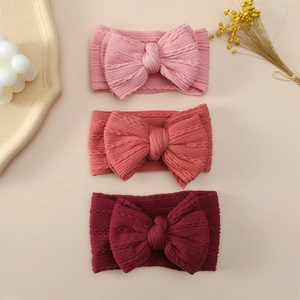 Detailed knit texture on soft nylon baby headbands with large double layer bows