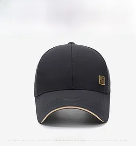 Detail of a black breathable mesh baseball cap with a gold square metal side logo