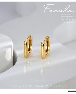 Macro detail of geometric square 18K gold-plated U-shaped earrings with a polished finish