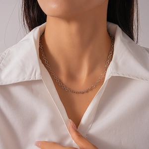 Minimalist silver geometric O-ring choker necklace worn with white shirt for women
