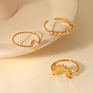Detailed view of 18k gold plated ring set with teardrop zircon and sunburst design