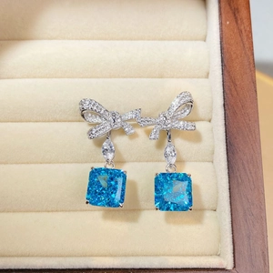 Elegant S925 silver bow earrings with square blue zircon dangles in velvet jewelry box