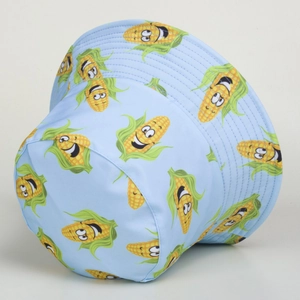 Detail shot of blue bucket hat with cute cartoon corn print and neat stitching details