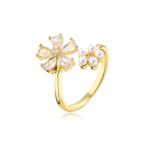 Detail of adjustable gold ring with floral zircon petals and miniature pearl cluster
