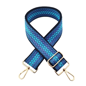 Close-up of blue diamond pattern woven shoulder strap with gold metal swivel lobster hooks