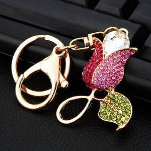 Close-up of tulip keychain with pink and green rhinestones on gold metal base