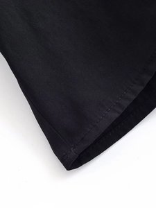 Close-up of black blouse sleeve showing fine fabric texture and double-stitched hem details