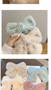 Detail of plush faux fur bow hair clips in pastel colors including blue, beige, and pink