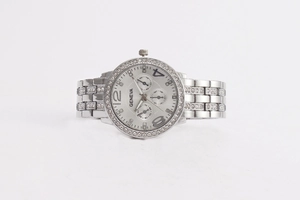 Detail view of silver Geneva watch featuring a diamond-encrusted bezel and metallic band