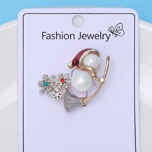 Detail of Christmas snowman brooch with pearls, red enamel hat and sparkling rhinestones