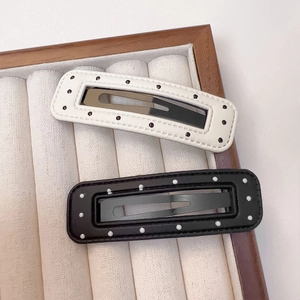Retro PU leather hair clips set with polka dots and stitching on jewelry display tray