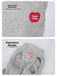 Detail of grey pet vest showing the red apple PVC badge and sleeveless knitted cotton design