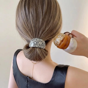 Elegant curved acetate hair rings set in leopard and marble patterns for ponytails
