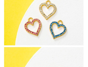 Detail of heart-shaped hollow charms with inlaid crystals in white, pink and blue tones