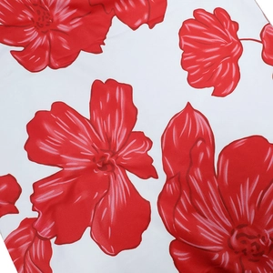Detail of vibrant red floral print on white breathable fabric for summer long dress