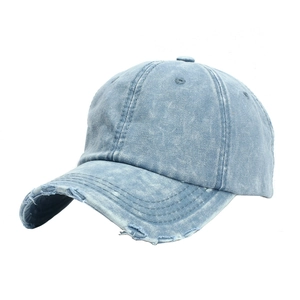 Close-up of light blue distressed denim baseball cap showing vintage frayed edge details