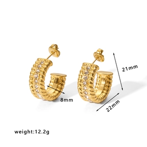 Detailed view of gold C-shaped hoop earrings with rope texture and zircon inlay
