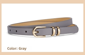 Detail of grey thin waist belt with a golden horseshoe buckle for summer dresses