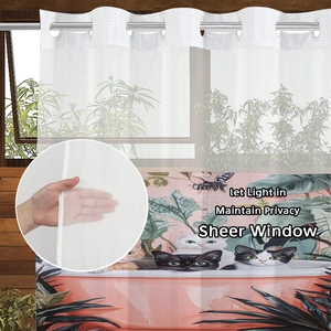 Detail showing semi-transparent sheer curtain with cat and plant print let light in