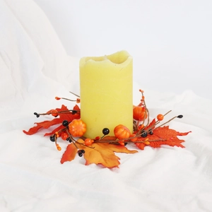 Detail of autumn candle ring with maple leaves, pumpkins and berries for Halloween decor