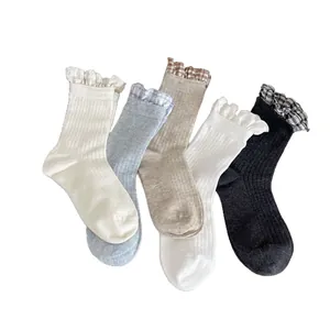 Five pack of women's ribbed mid-calf socks with elegant frill trim in assorted colors