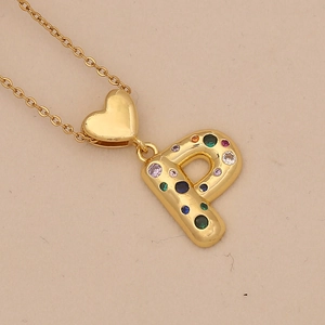 Detail of a gold letter P pendant featuring colorful zircon stones and heart charm