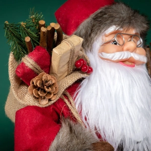 Standing Santa Claus doll in red plush coat with gift bag and pine cones ornament