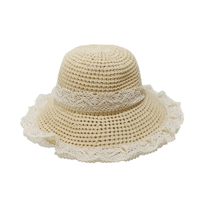 Close-up of beige straw sun hat featuring intricate white lace trim and woven texture