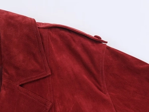 Close-up of red suede jacket collar with epaulettes and detailed stitching