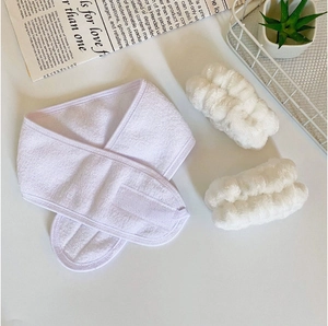 Detailed view of white microfiber spa set including velcro headband and wristbands