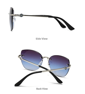 Detail view of rimless cat eye sunglasses with gradient lenses and silver metal temples