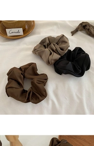 Three premium matte satin scrunchies in brown, khaki, and black on white fabric