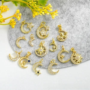 Vue détaillée de breloques lune et étoile plaquées or 18 carats avec pierres en zircone