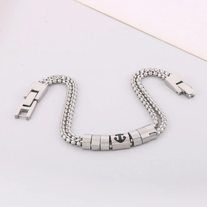 Dettaglio del bracciale in acciaio inossidabile argento con tripla catena intrecciata e ancora
