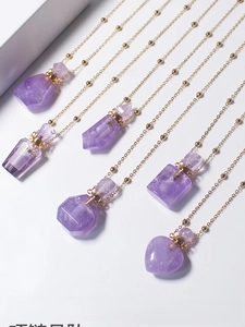 Detailed view of amethyst perfume bottle pendants in various shapes with gold bead chains