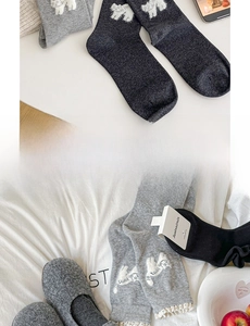 Detail of cute cat pattern socks with lace trim in gray and charcoal knit cotton