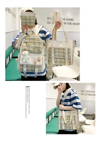 Detail view of the 4-piece plaid backpack set featuring a teddy bear and badges