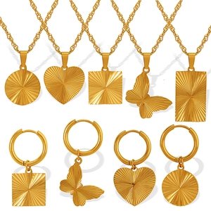 Golden butterfly and heart pendant jewelry set featuring necklaces and earrings